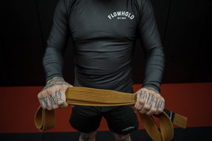 man holding jiu jitsu belt